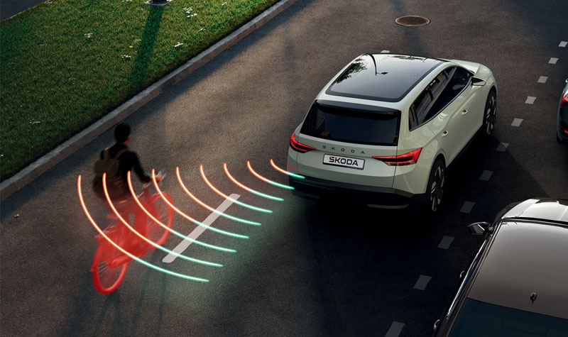 A skoda with rear sensors detecting a syclist