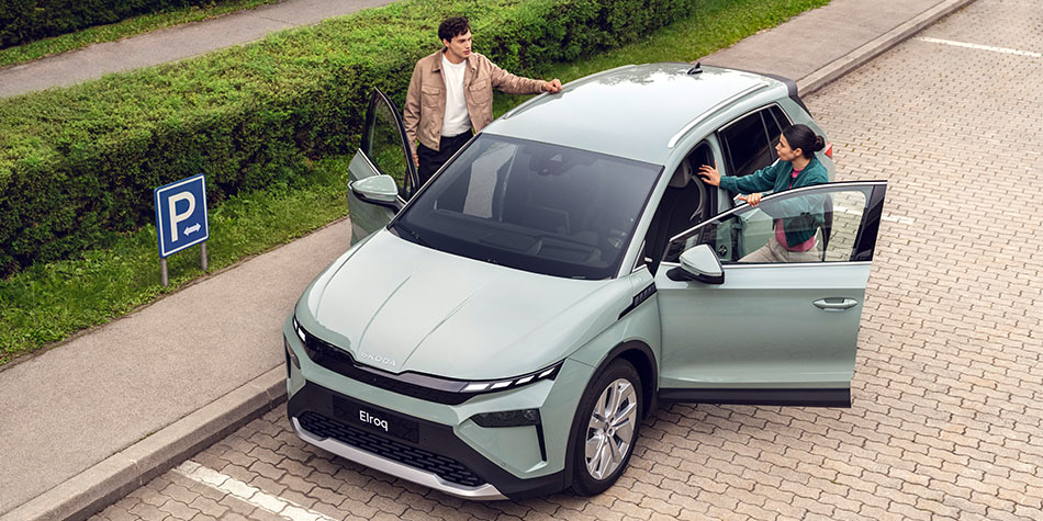 High angle of two people standing by the doors of an Elroq