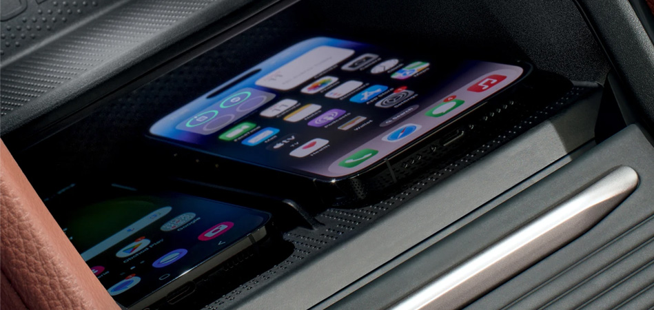 Two phones in a centre console of a Skoda charging