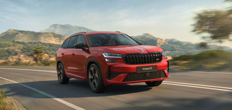 Red Sports SUV driving on a sea side road