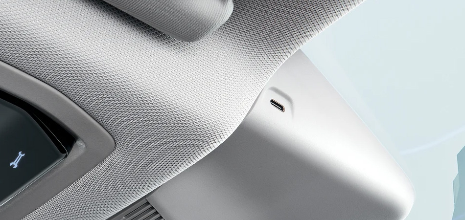 Close up image of a USB-C port on the side of a reverse mirror in an SUV