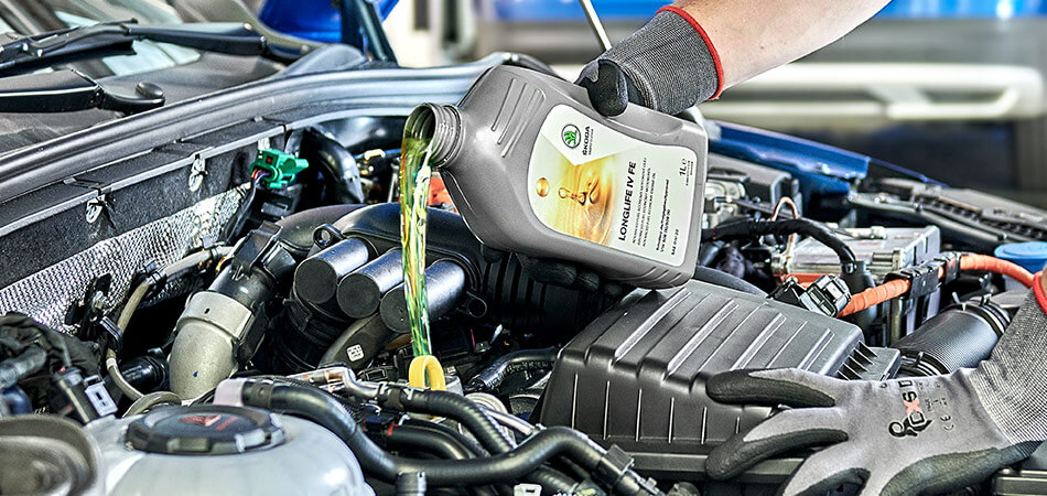 Approved oil being poured into a SKoda during its service